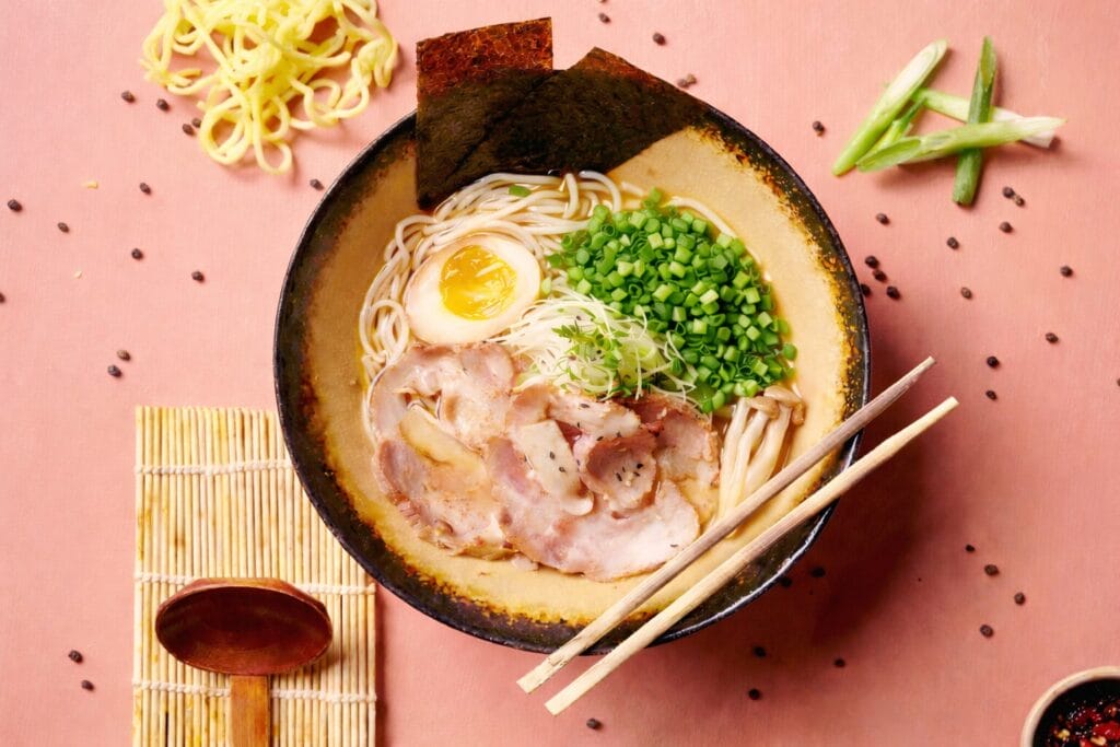 Bowl of miso ramen with chashu pork, soft boiled egg, noodles, bok choy and nori in rich miso broth.